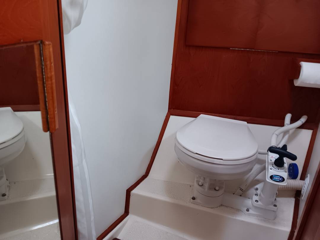 Marine toilet in the enclosed head compartment